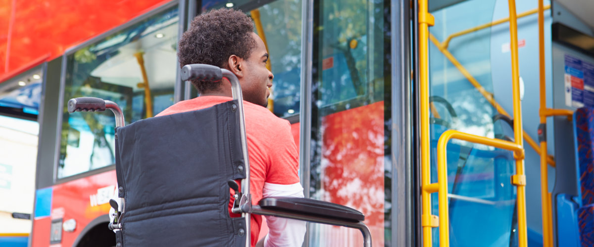 Man In Wheelchair Boarding Bus By Himself Struggling