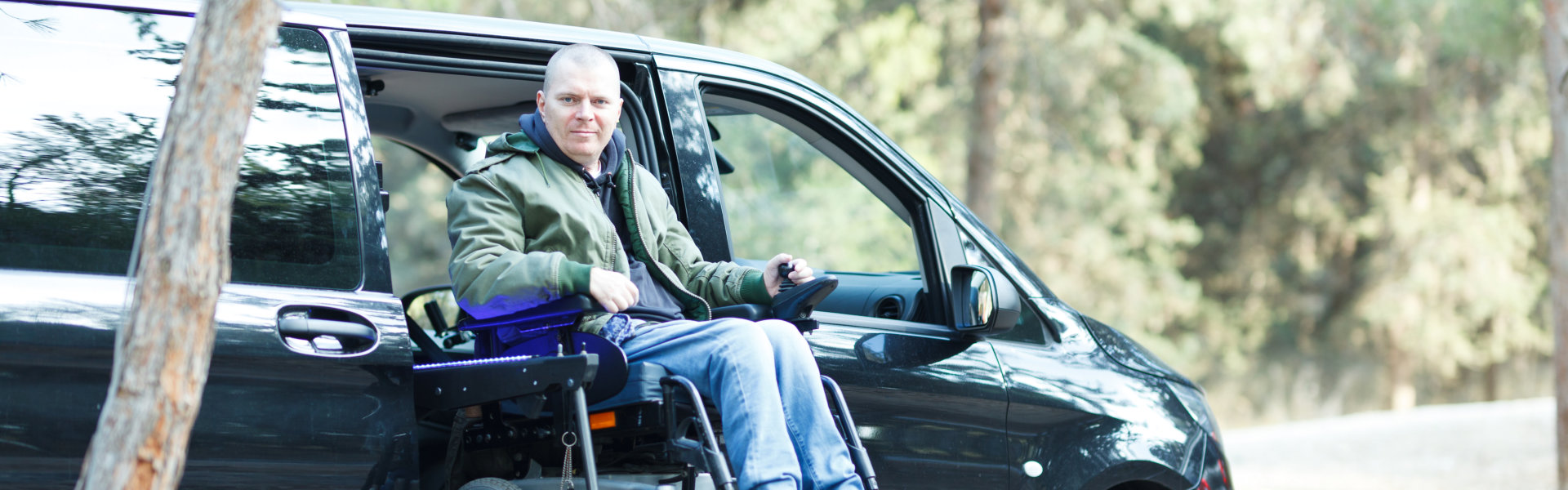 man on wheelchair standing on the car lift