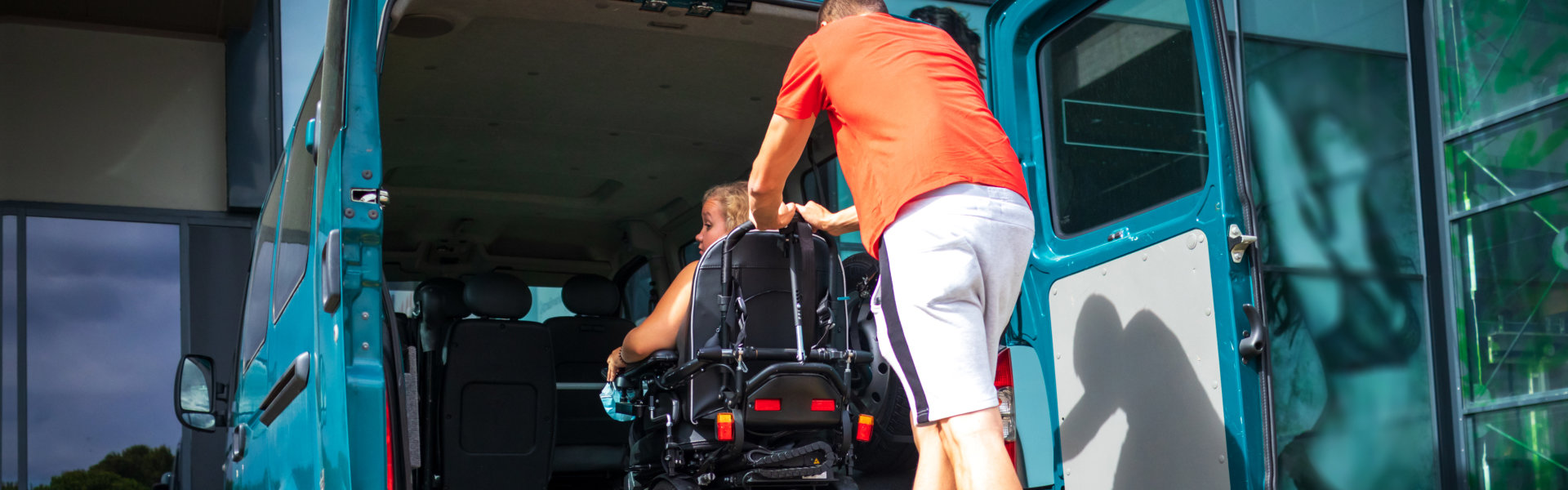 Woman on wheelchair using a vehicle ramp