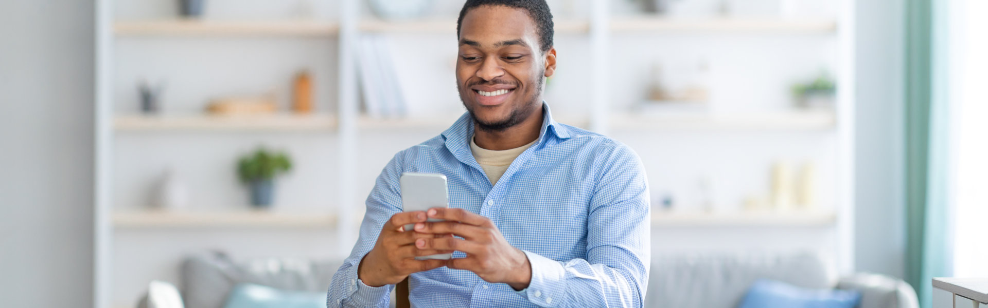 man in wheelchair using smartphone